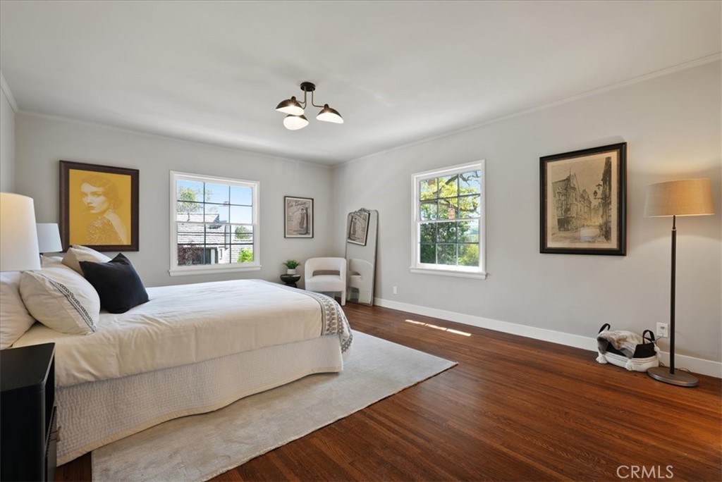 7404 Woodrow Wilson Drive Los Angeles, CA 90046 - Photo 27 of 57 a bedroom with a bed and wooden floor