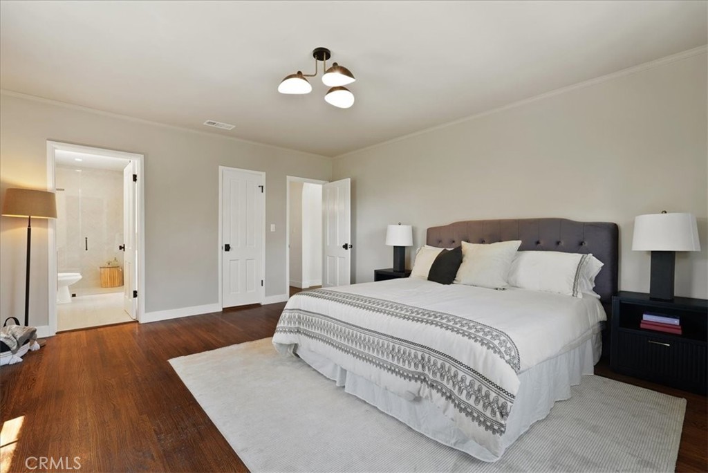 7404 Woodrow Wilson Drive Los Angeles, CA 90046 - Photo 28 of 57 a spacious bedroom with a bed and a chandelier