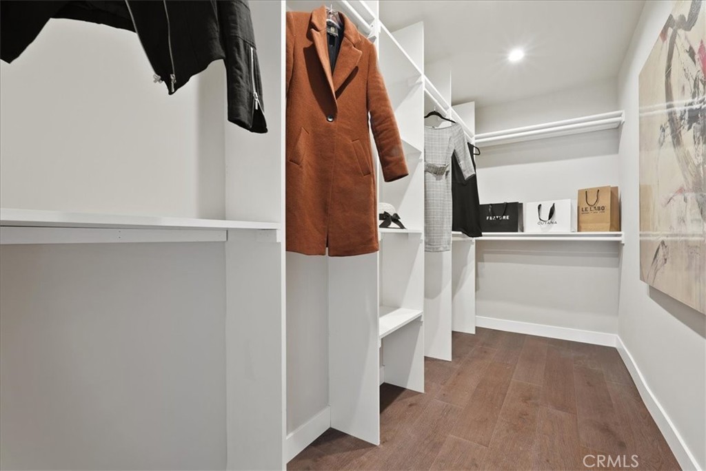 7404 Woodrow Wilson Drive Los Angeles, CA 90046 - Photo 29 of 57 a view of walk in closet with clothes and shoes
