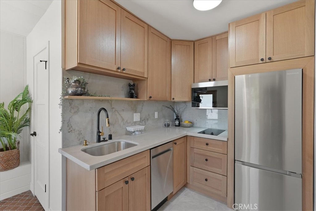 7404 Woodrow Wilson Drive Los Angeles, CA 90046 - Photo 34 of 57 a kitchen with appliances a sink and cabinets