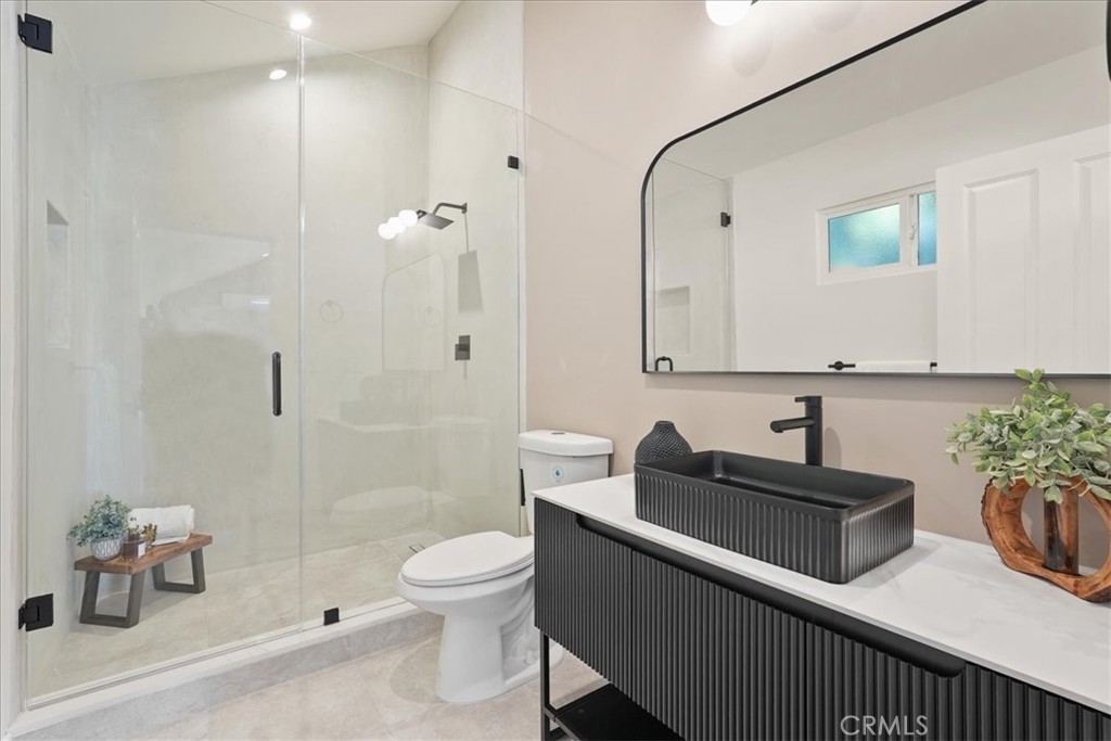 7404 Woodrow Wilson Drive Los Angeles, CA 90046 - Photo 43 of 57 a bathroom with a sink a toilet and shower