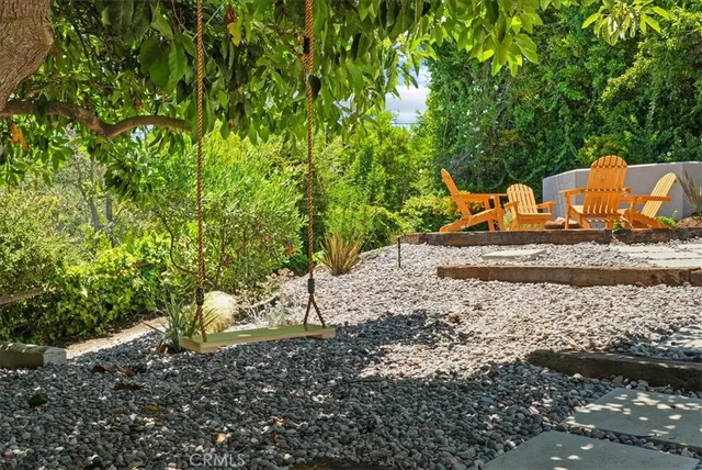 an aerial view of a house with garden space and street view