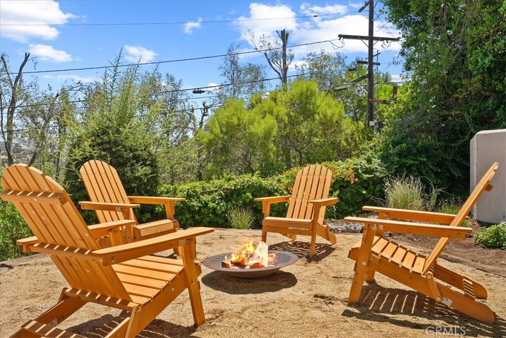 7404 Woodrow Wilson Drive Los Angeles, CA 90046 - Photo 51 of 57 a view of a patio with table and chairs and wooden floor