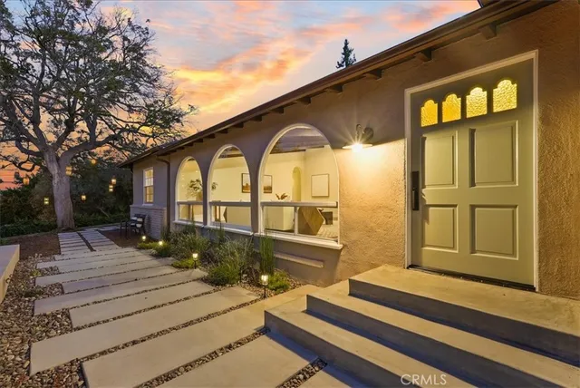 a front view of a house with a garden