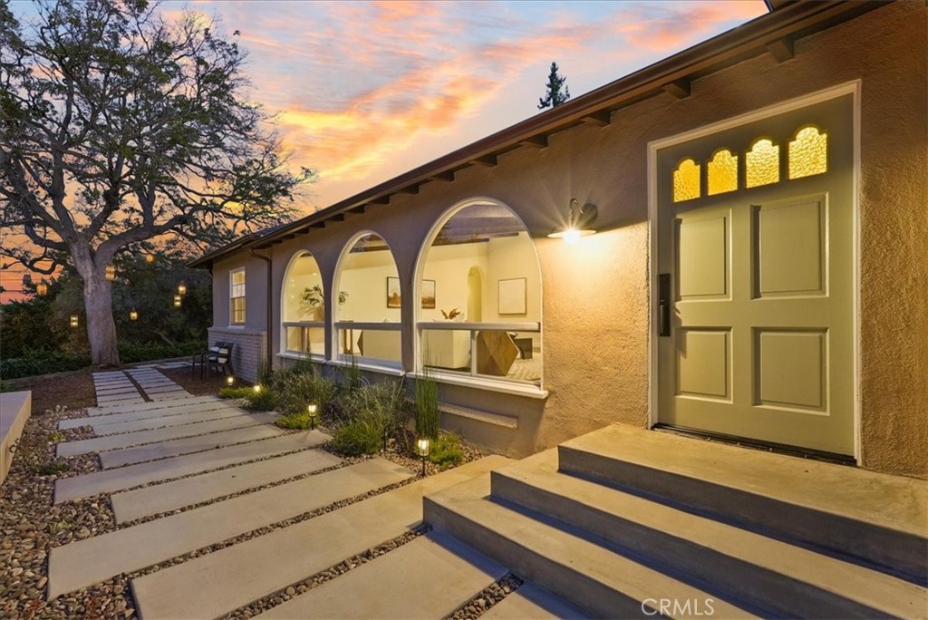 7404 Woodrow Wilson Drive Los Angeles, CA 90046 - Photo 6 of 57 a front view of a house with a garden