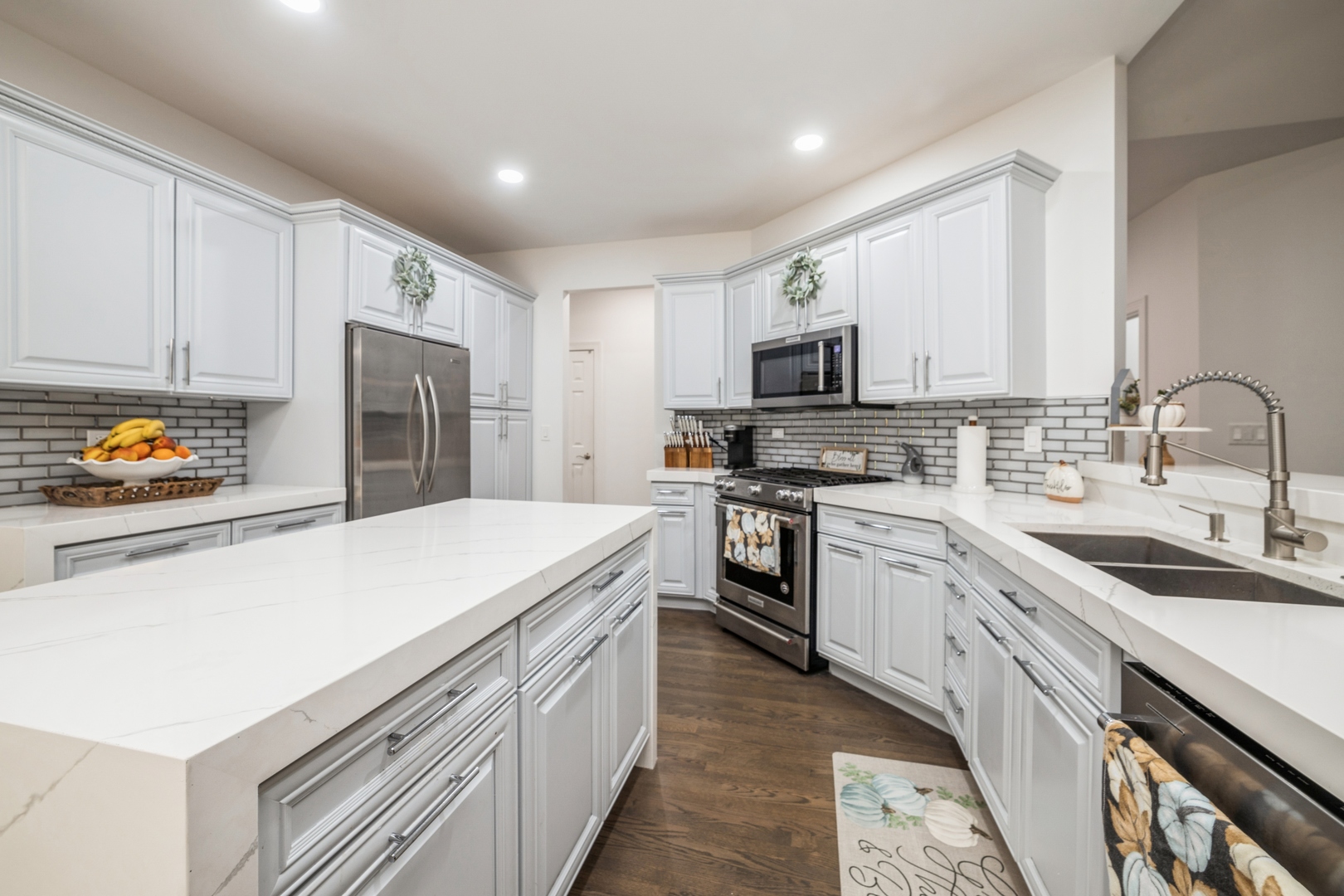 19217 Beck Road Marengo, IL 60152 - Photo 7 of 30 a kitchen with stainless steel appliances a stove a sink a refrigerator a microwave a cabinets and wooden floor