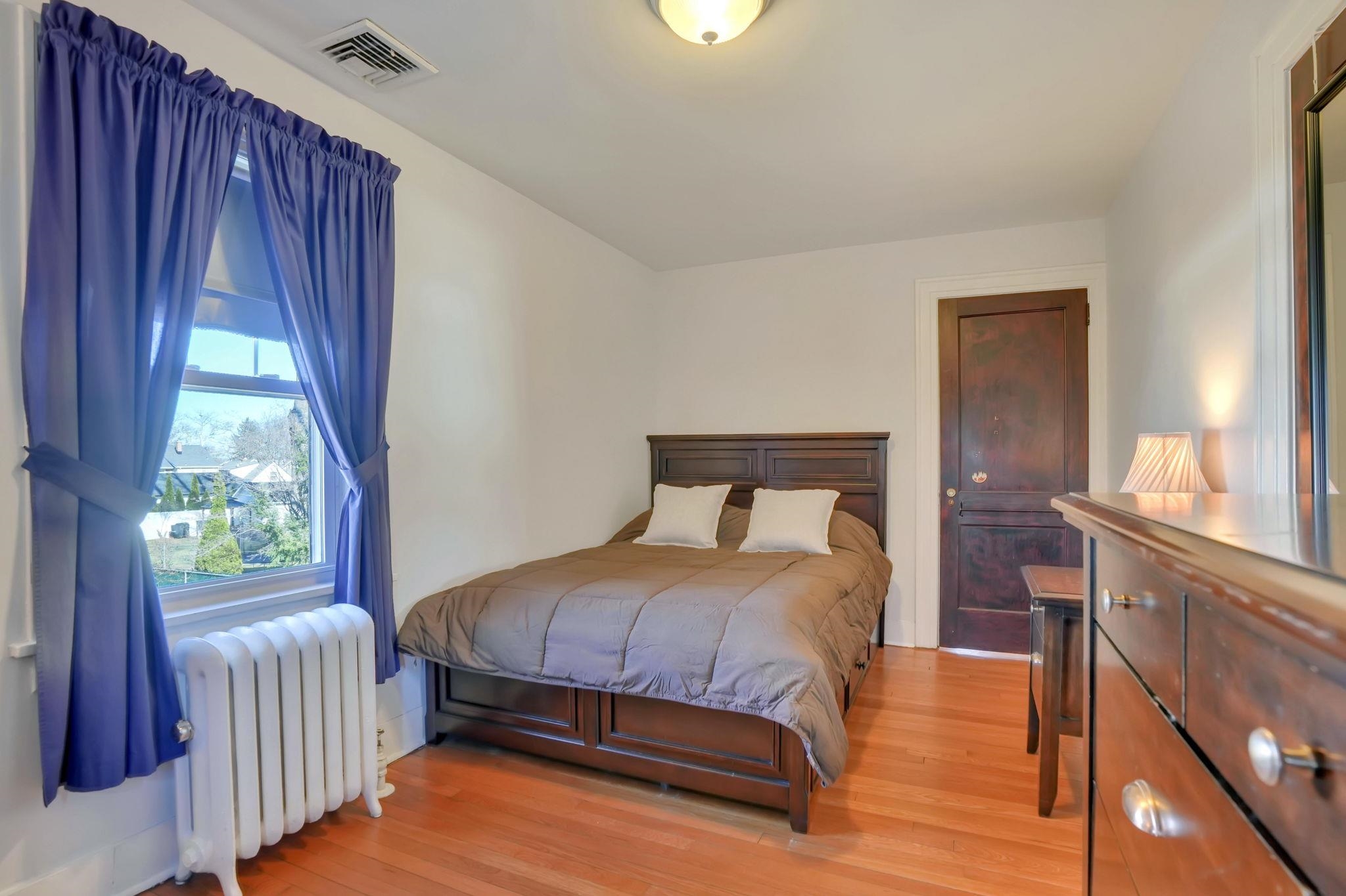 10 Lynn Court Rutherford, NJ 07070 - Photo 18 of 37 a bedroom with a bed and a window
