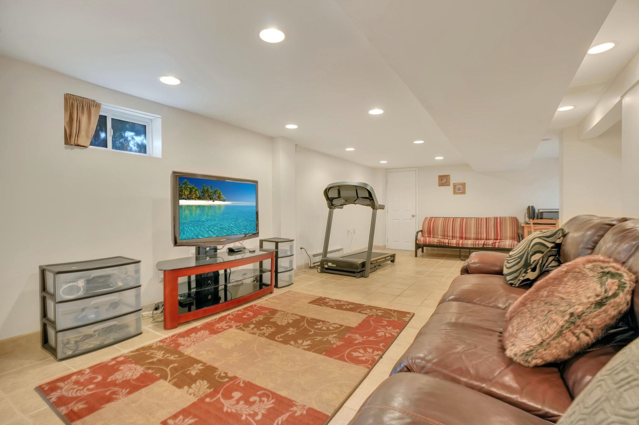 10 Lynn Court Rutherford, NJ 07070 - Photo 24 of 37 a living room with furniture and a flat screen tv