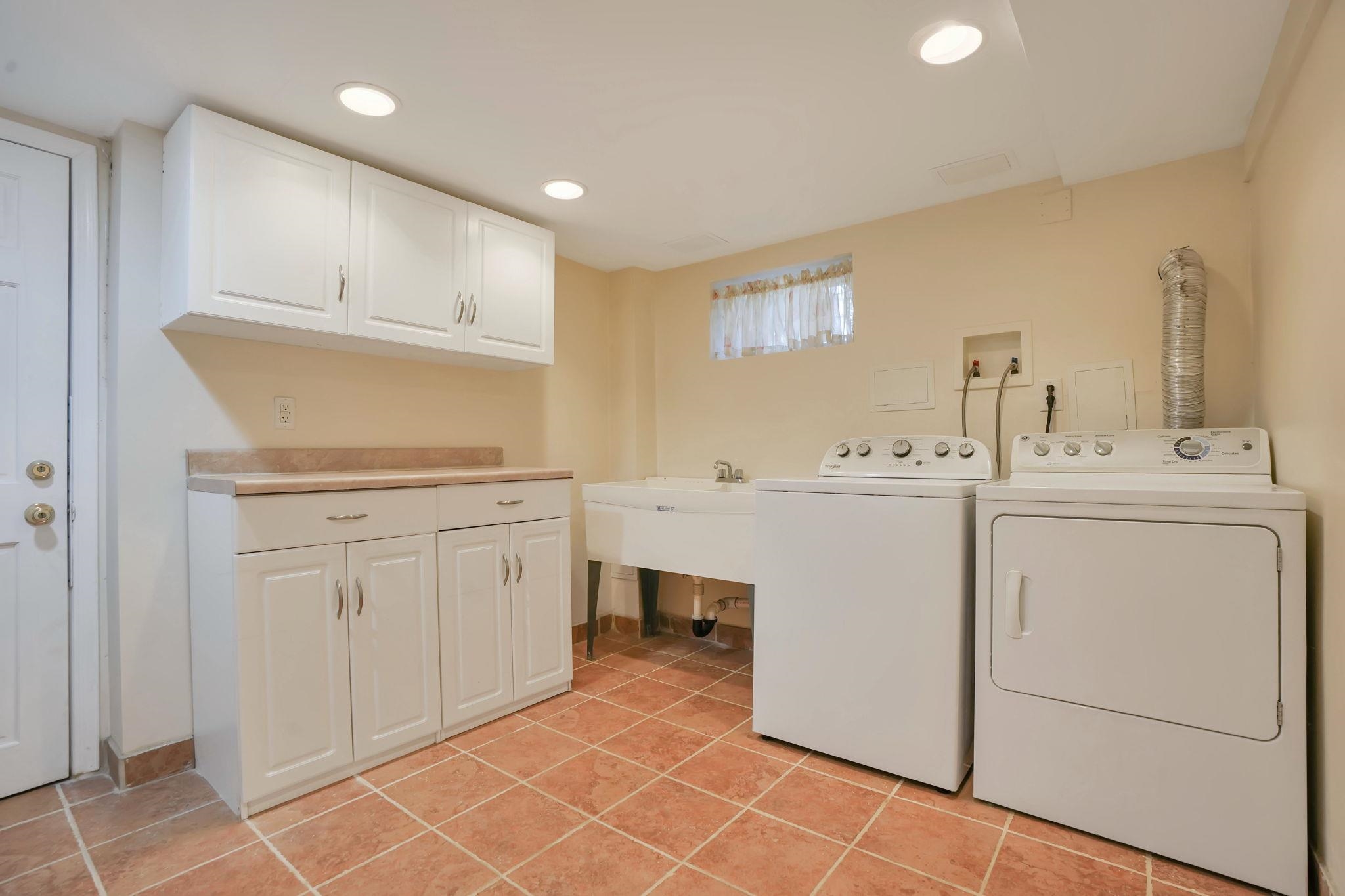10 Lynn Court Rutherford, NJ 07070 - Photo 27 of 37 a utility room with cabinets washer and dryer