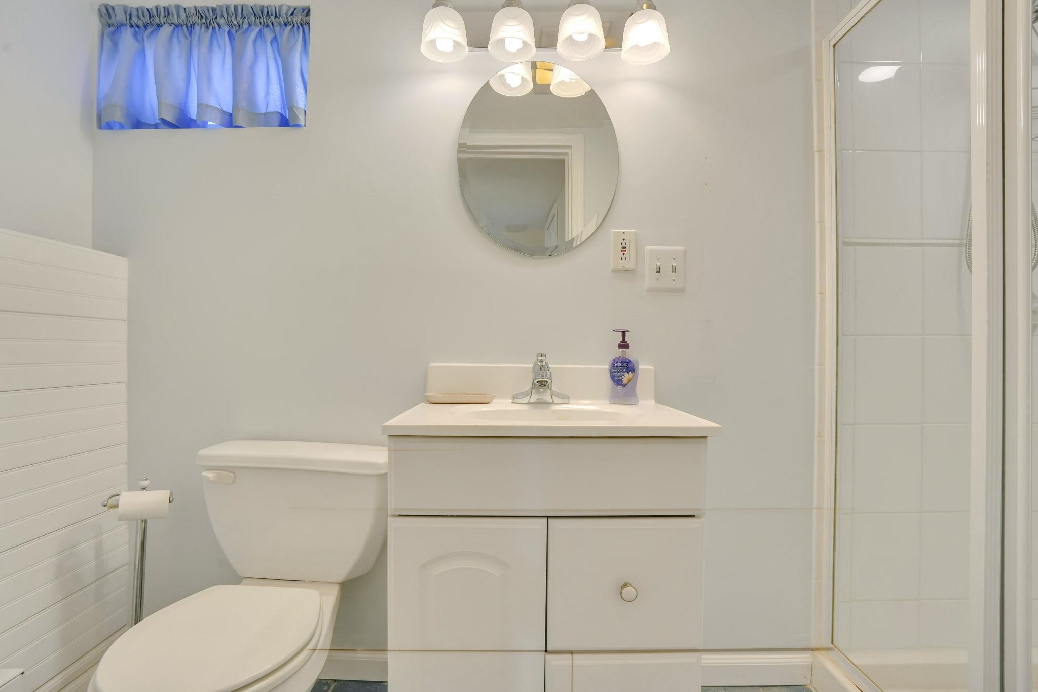 10 Lynn Court Rutherford, NJ 07070 - Photo 28 of 37 a bathroom with a toilet a sink and mirror