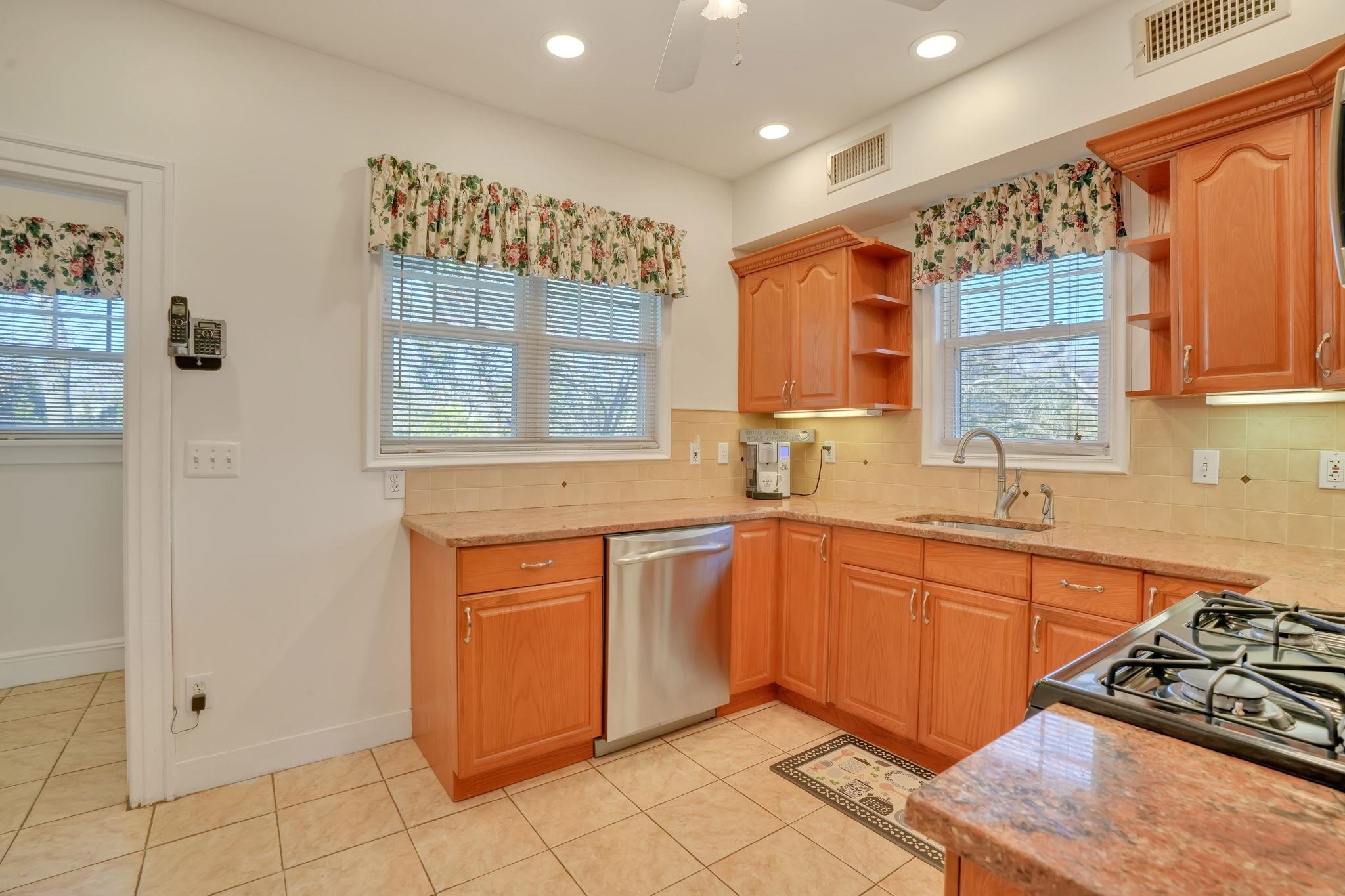 10 Lynn Court Rutherford, NJ 07070 - Photo 8 of 37 a kitchen with stainless steel appliances granite countertop a stove sink and cabinets