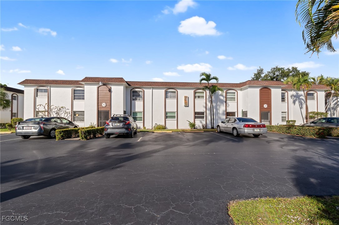 2828 Jackson Street, Unit D8 Fort Myers, FL 33901 - Photo 1 of 37 a view of a street with couple of cars parked in front of it