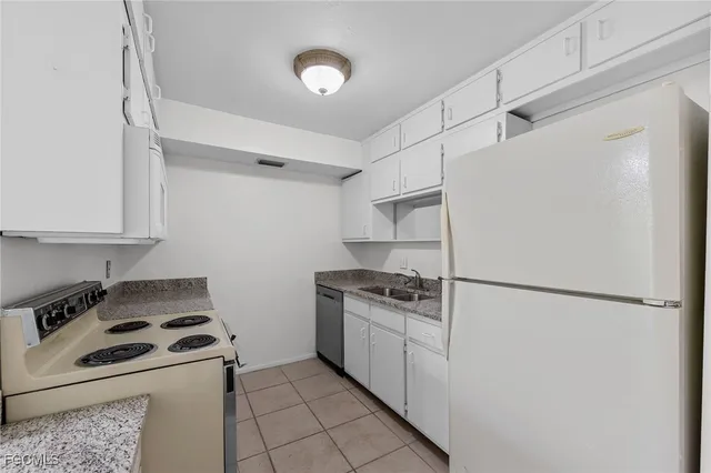 a kitchen with a stove and a refrigerator