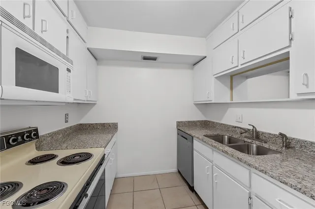 a kitchen with stainless steel appliances granite countertop a sink and cabinets