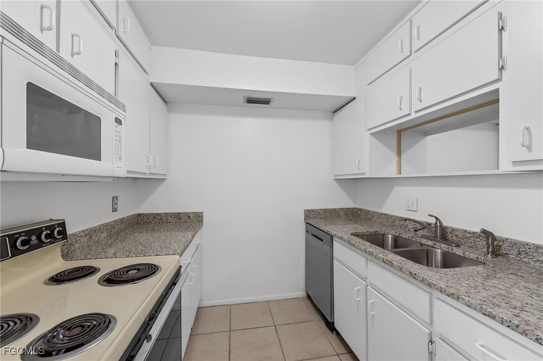 2828 Jackson Street, Unit D8 Fort Myers, FL 33901 - Photo 12 of 37 a kitchen with stainless steel appliances granite countertop a sink and cabinets