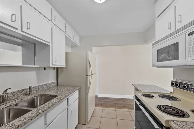 a kitchen that has a sink and a stove