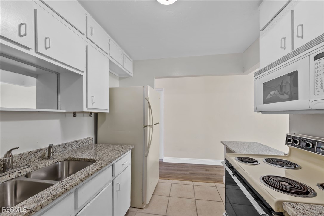 2828 Jackson Street, Unit D8 Fort Myers, FL 33901 - Photo 13 of 37 a kitchen that has a sink and a stove