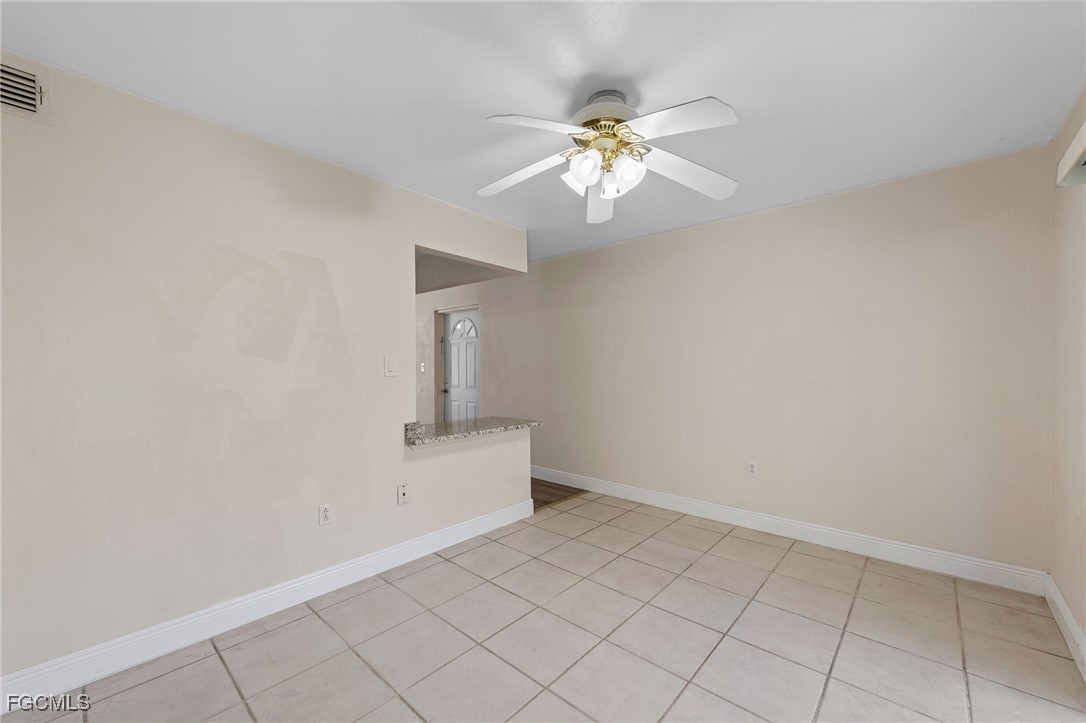 2828 Jackson Street, Unit D8 Fort Myers, FL 33901 - Photo 16 of 37 a view of an empty room and chandelier fan