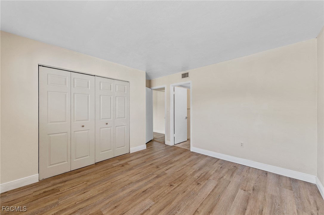 2828 Jackson Street, Unit D8 Fort Myers, FL 33901 - Photo 23 of 37 a view of an empty room and wooden floor