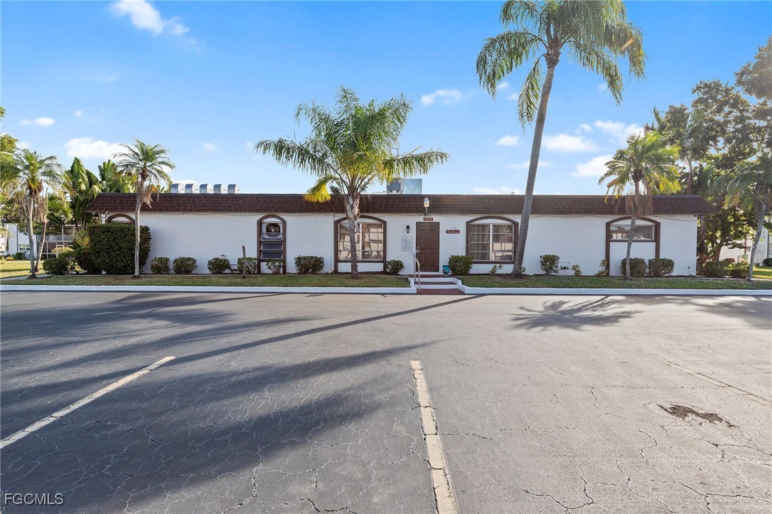 2828 Jackson Street, Unit D8 Fort Myers, FL 33901 - Photo 31 of 37 front view of a house with a yard and palm trees