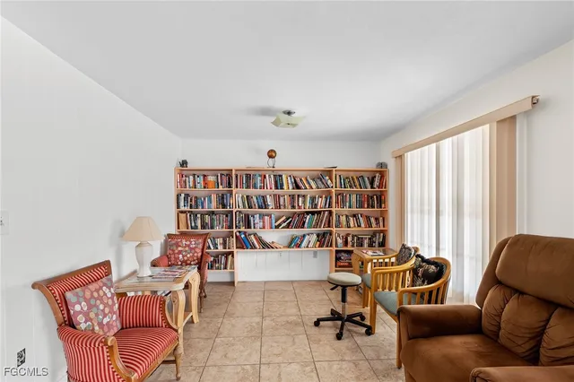 a living room with furniture and kitchen view