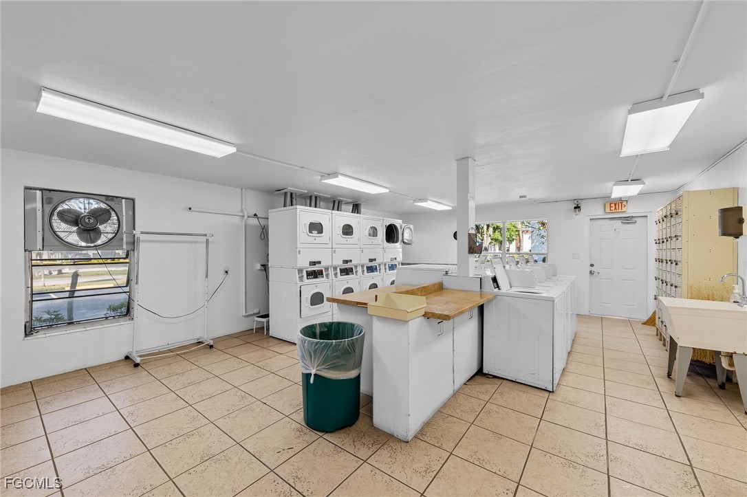 2828 Jackson Street, Unit D8 Fort Myers, FL 33901 - Photo 37 of 37 a kitchen with stainless steel appliances kitchen island granite countertop a refrigerator and a stove