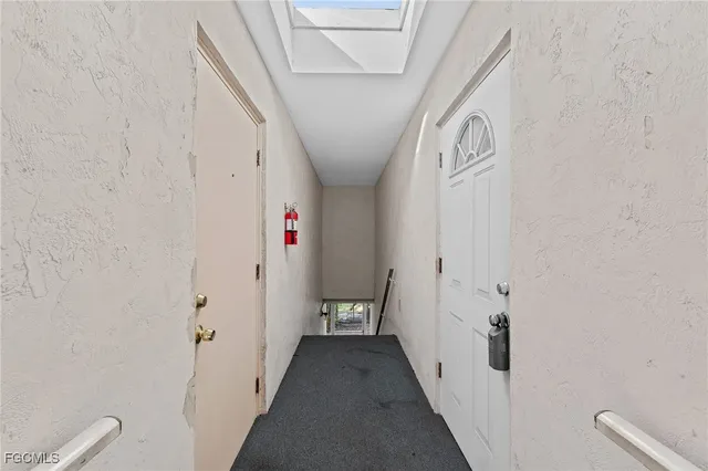 a view of a hallway with wooden floor and closet