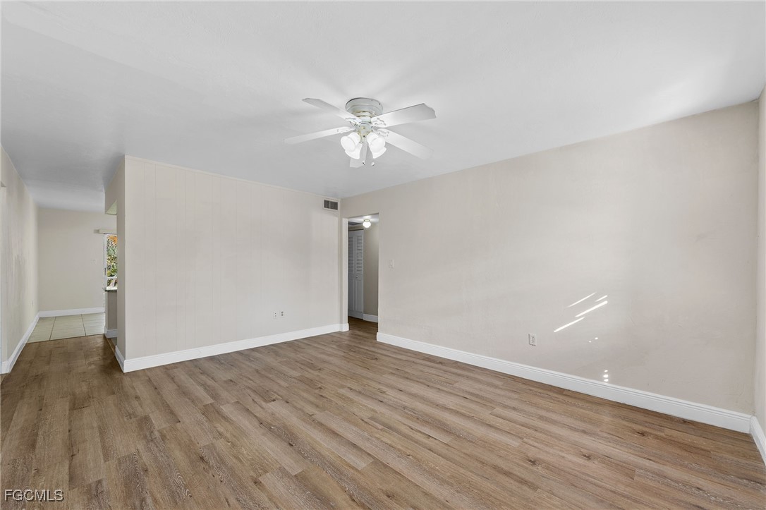2828 Jackson Street, Unit D8 Fort Myers, FL 33901 - Photo 8 of 37 a view of an empty room with wooden floor