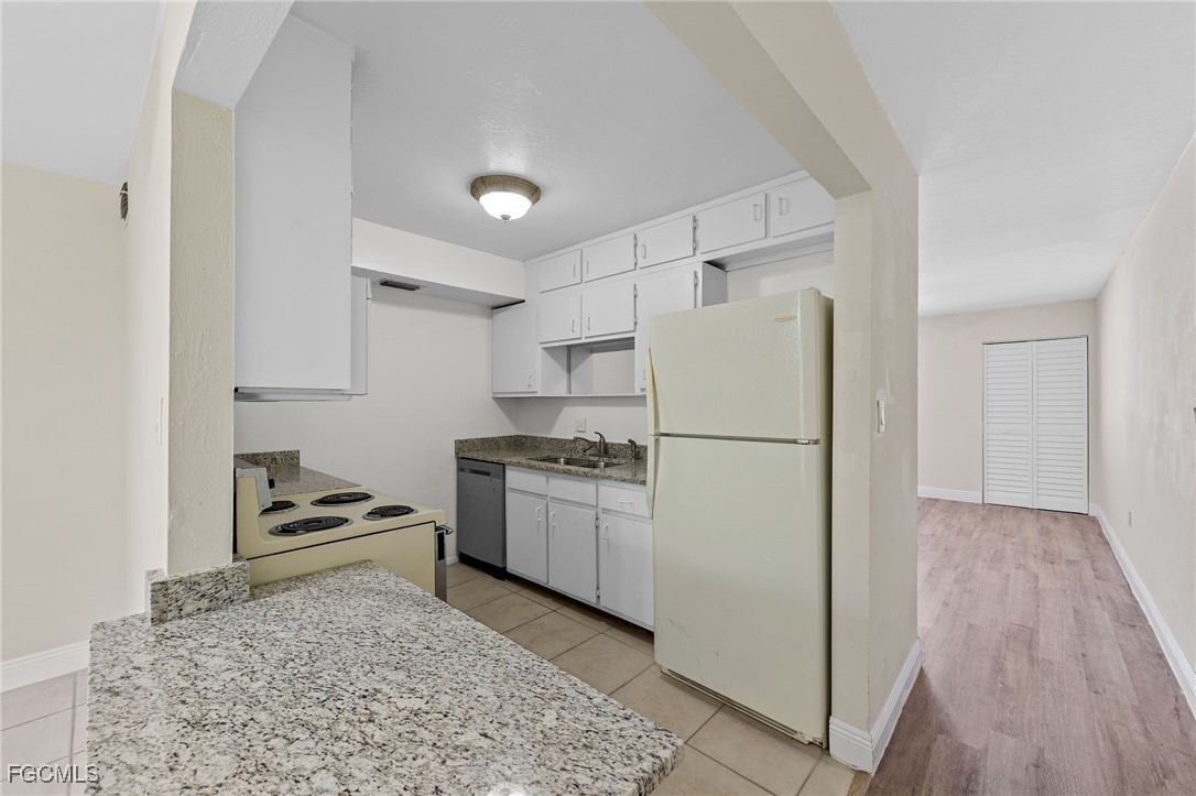 2828 Jackson Street, Unit D8 Fort Myers, FL 33901 - Photo 10 of 37 a kitchen with a refrigerator and a stove top oven