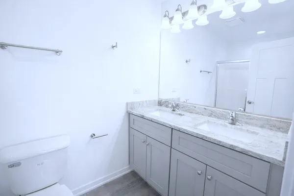 a bathroom with a granite countertop sink a large mirror and vanity