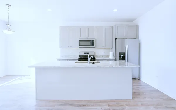 a kitchen with stainless steel appliances a refrigerator and a stove top oven