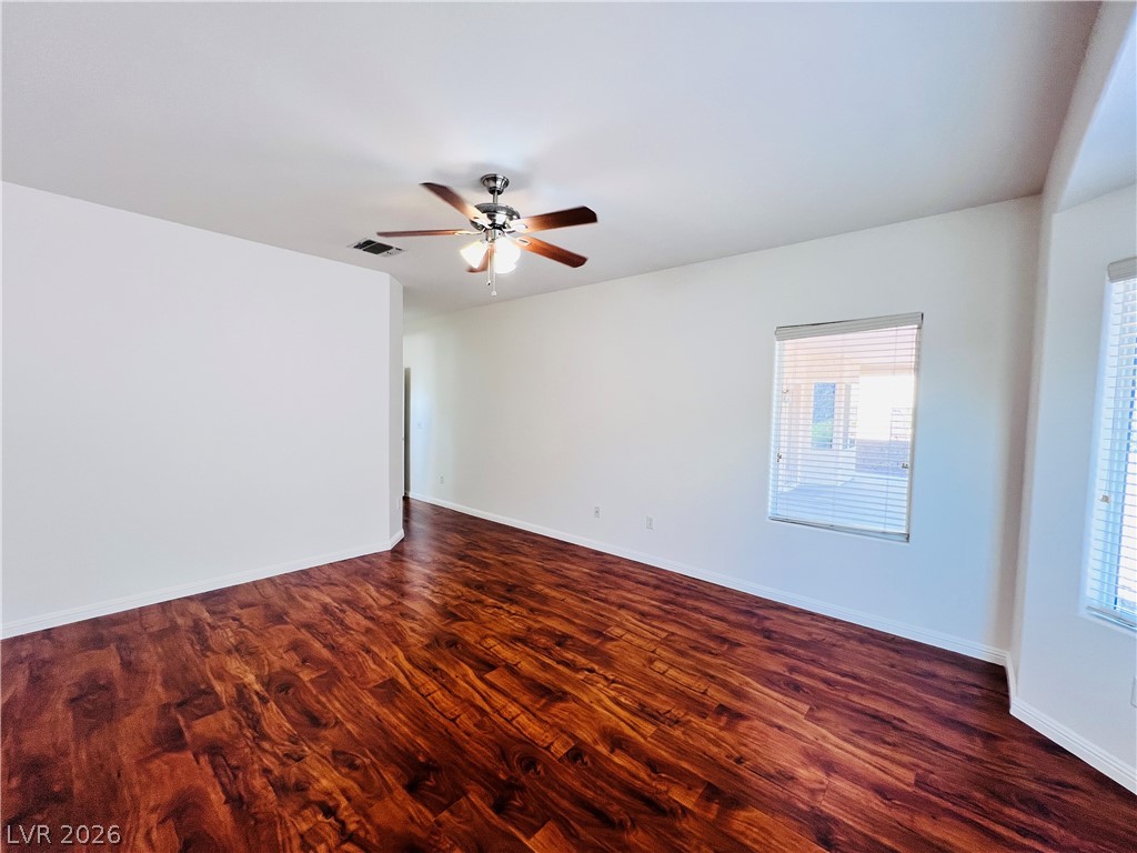 3047 Hickory Valley Road Henderson, NV 89052 - Photo 13 of 33 Warm wood flooring defines this generous room, ready for personalization.