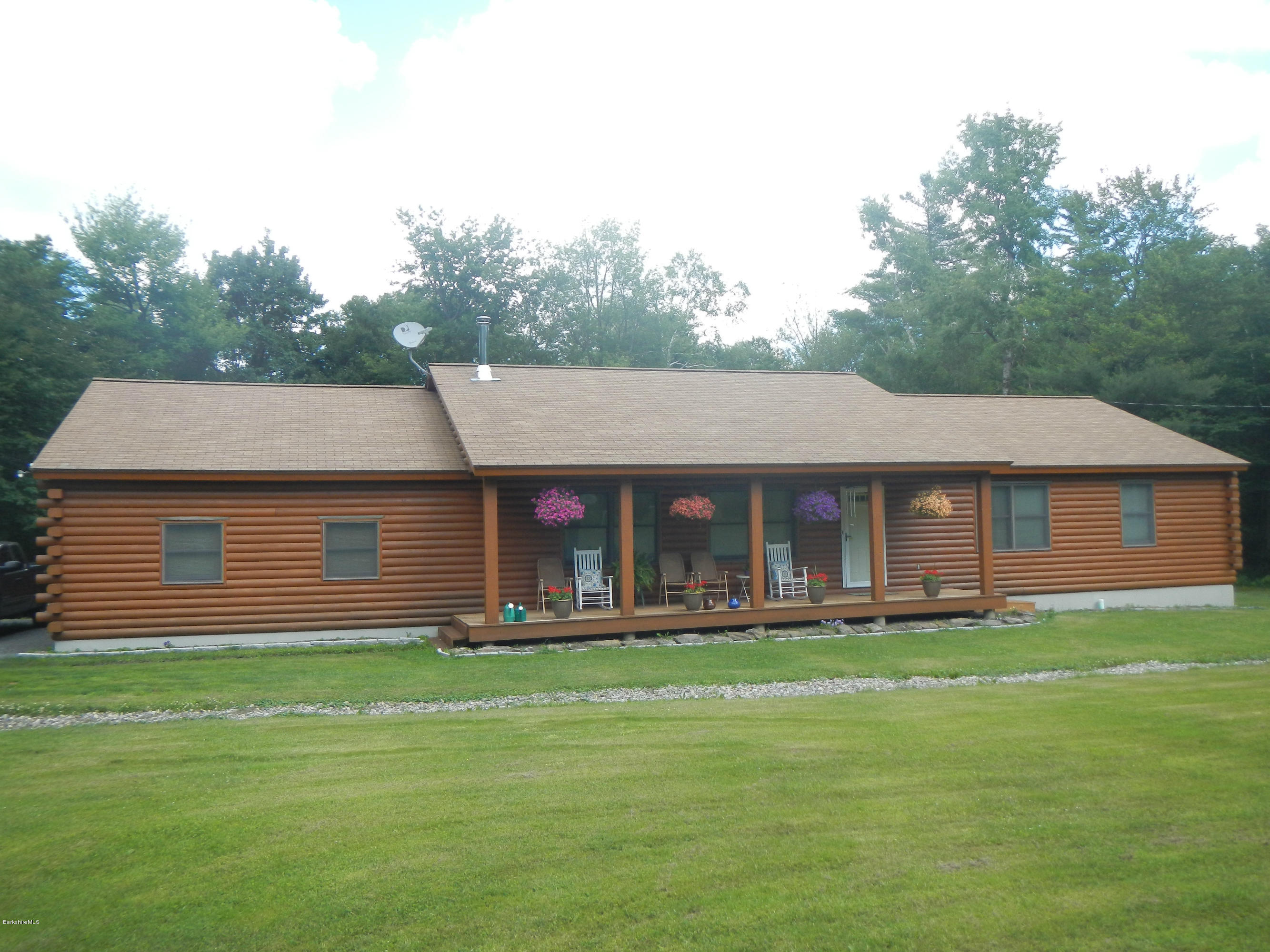 99 Strykers Road Florida, MA 01247 - Photo 1 of 26 a front view of a house with a yard