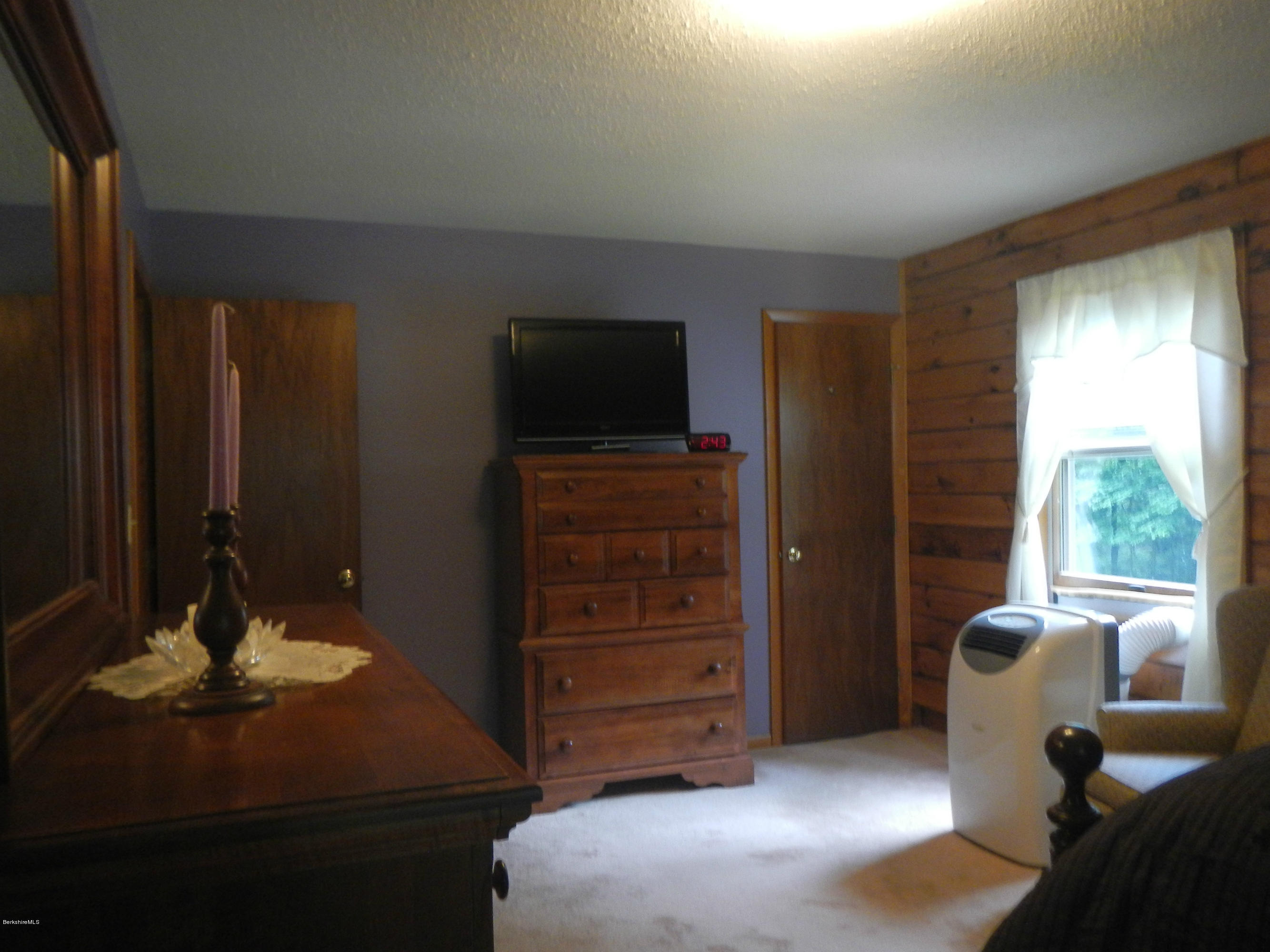 99 Strykers Road Florida, MA 01247 - Photo 11 of 26 a bedroom with a bed and furniture