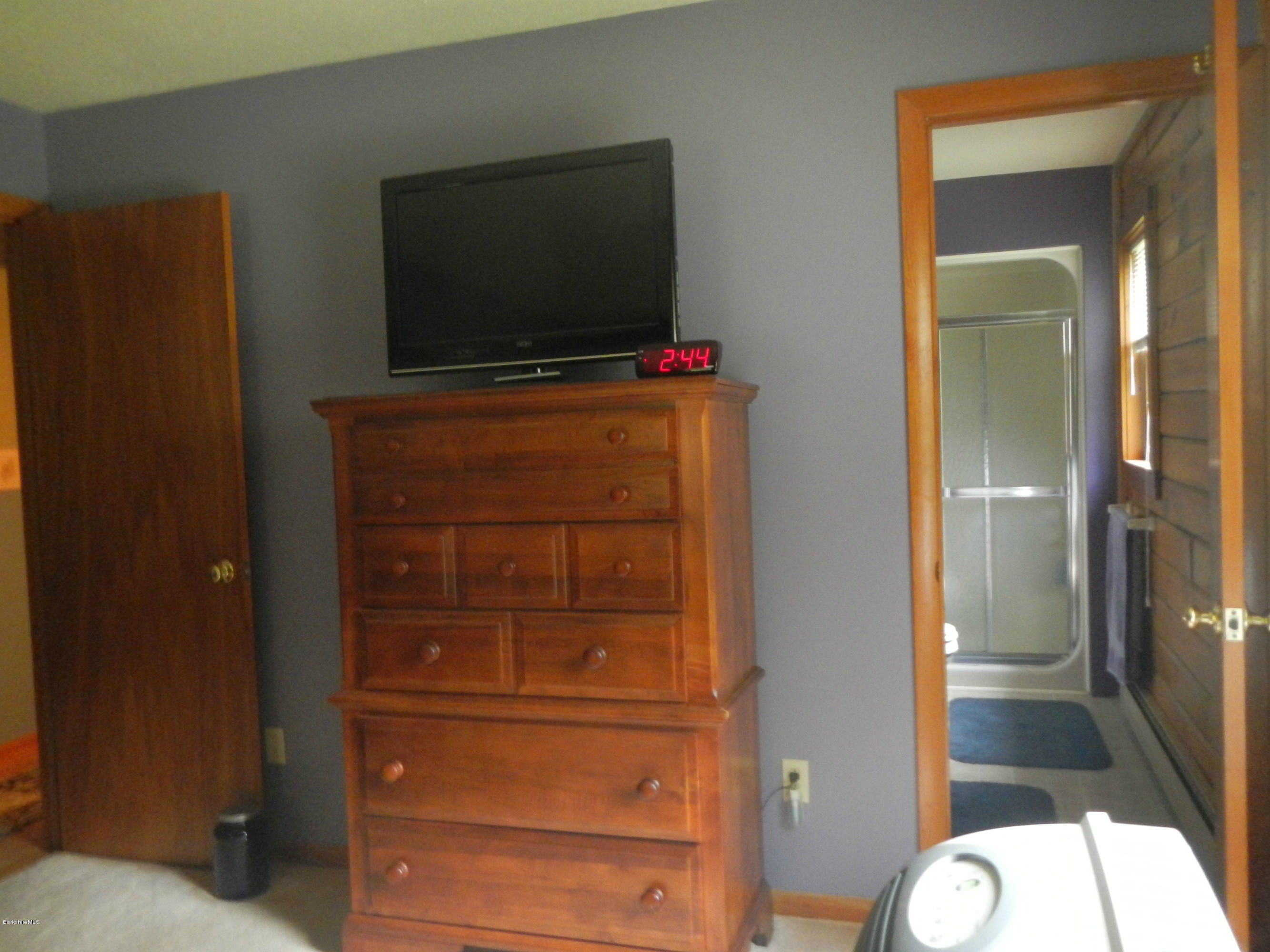 99 Strykers Road Florida, MA 01247 - Photo 14 of 26 a living room with a flat screen tv and a mirror