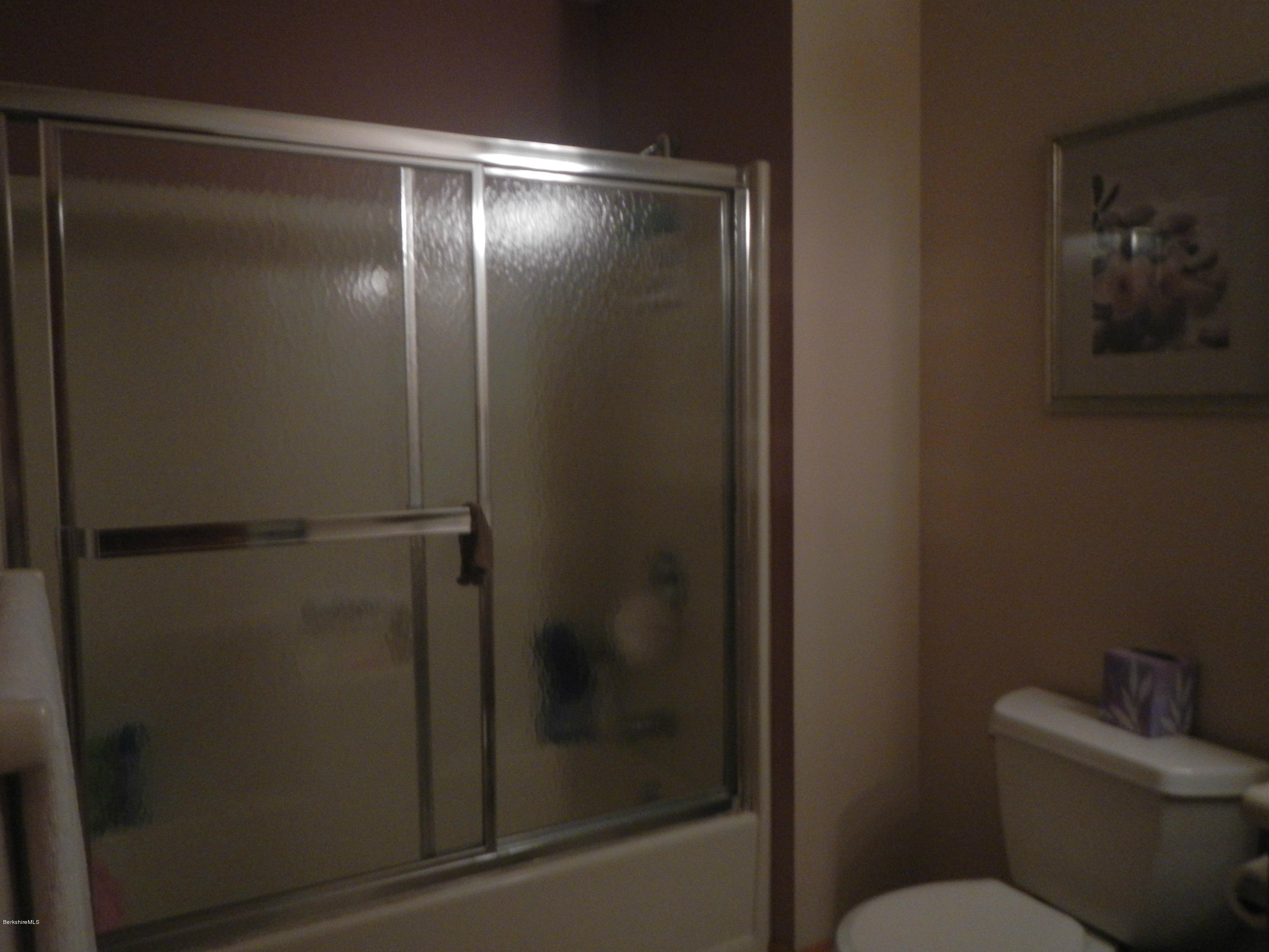 99 Strykers Road Florida, MA 01247 - Photo 21 of 26 a bathroom with a glass shower door