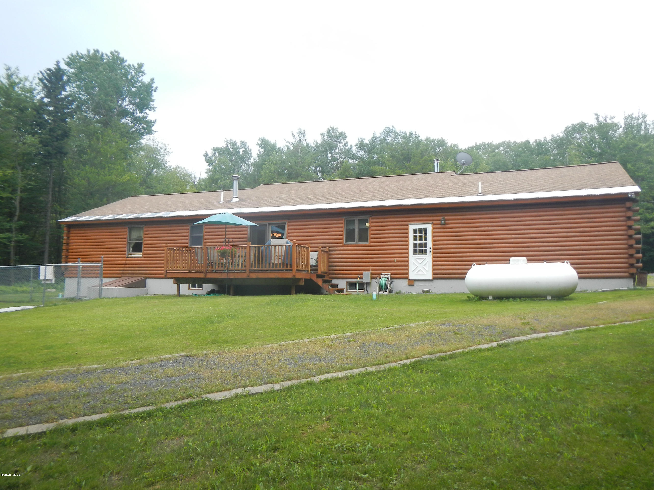 99 Strykers Road Florida, MA 01247 - Photo 25 of 26 a backyard of a house with table and chairs