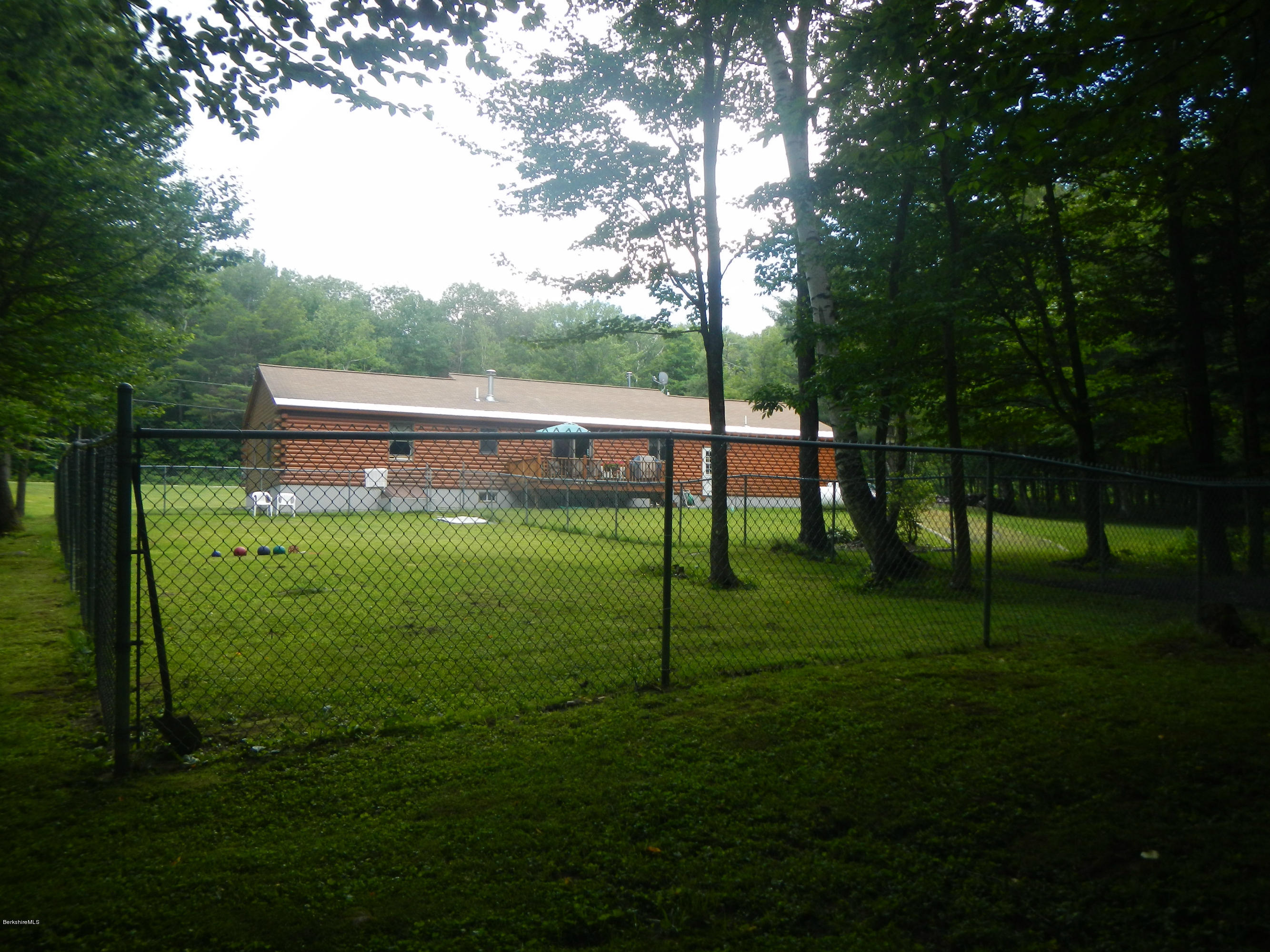 99 Strykers Road Florida, MA 01247 - Photo 26 of 26 a backyard of a house with lots of green space and fountain
