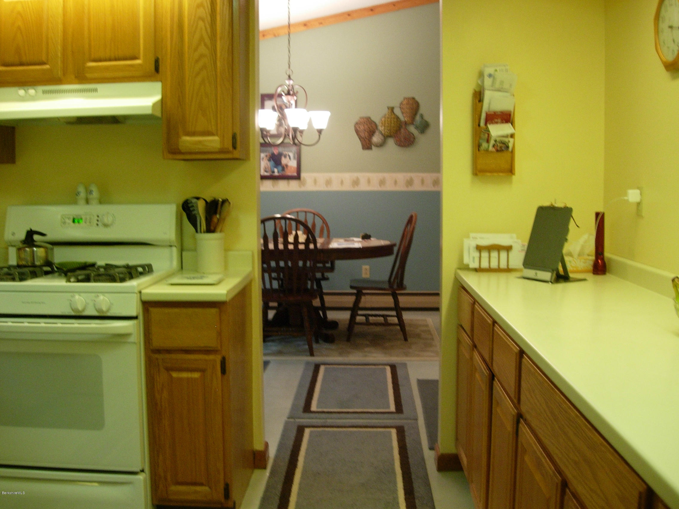 99 Strykers Road Florida, MA 01247 - Photo 4 of 26 a dining room with a sink and a stove next to a window