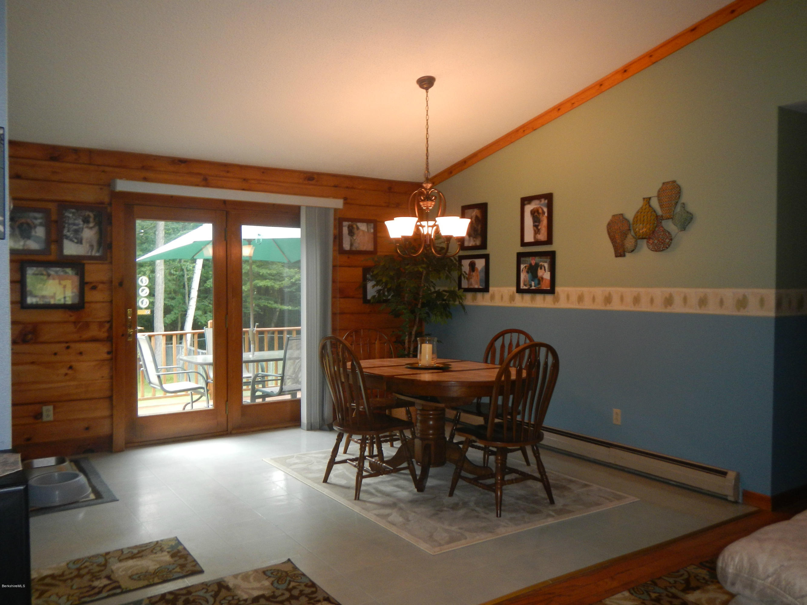 99 Strykers Road Florida, MA 01247 - Photo 6 of 26 a view of a dining room with furniture wooden floor and chandelier