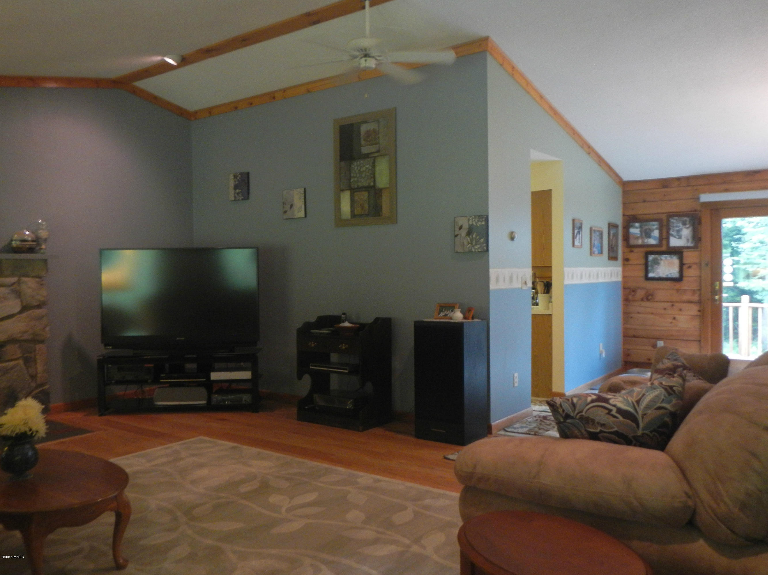 99 Strykers Road Florida, MA 01247 - Photo 7 of 26 a bedroom with furniture and a flat screen tv