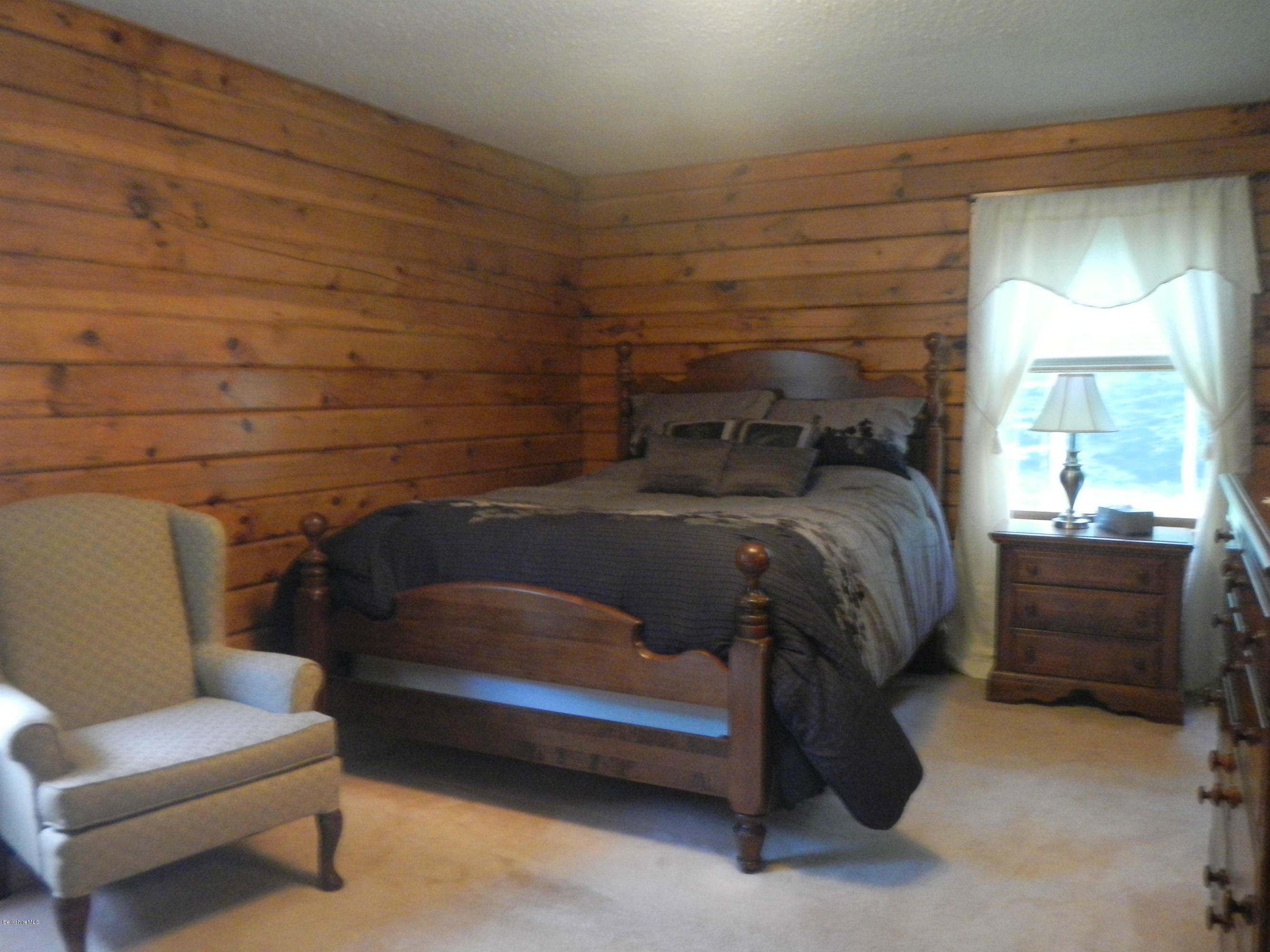 99 Strykers Road Florida, MA 01247 - Photo 10 of 26 a bedroom with a bed and a couch