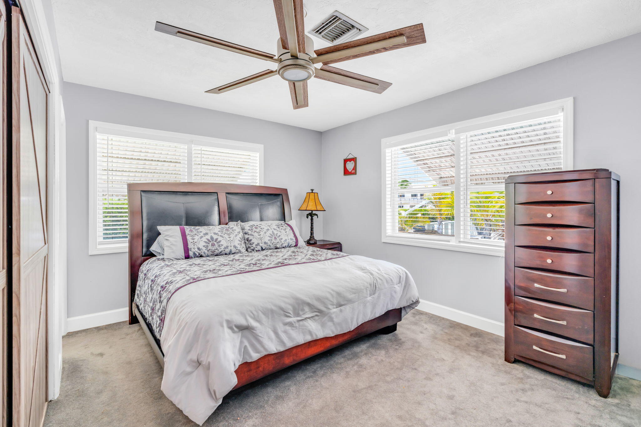 30366 Falcon Lane Big Pine Key, FL 33043 - Photo 17 of 45 a bedroom with a bed a dresser and a window