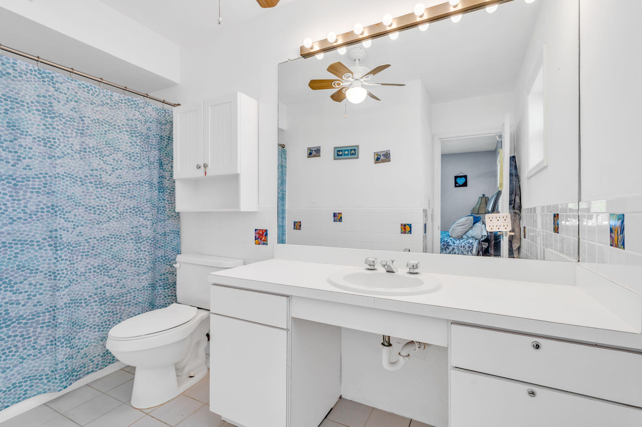 30366 Falcon Lane Big Pine Key, FL 33043 - Photo 18 of 45 a bathroom with a sink a toilet and mirror