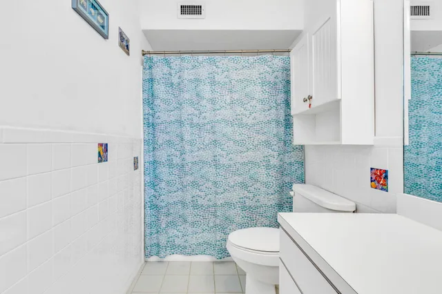 a bathroom with a sink a toilet and a shower