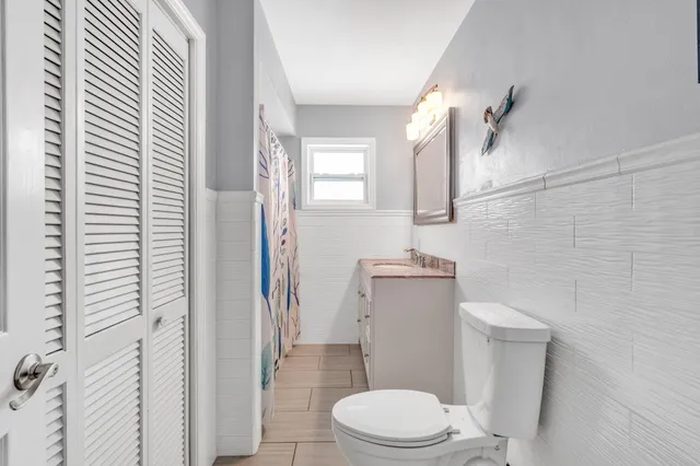 a white toilet sitting next to a bathroom sink