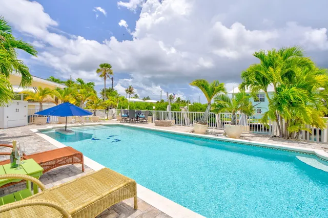 a view of a swimming pool and lounge chairs