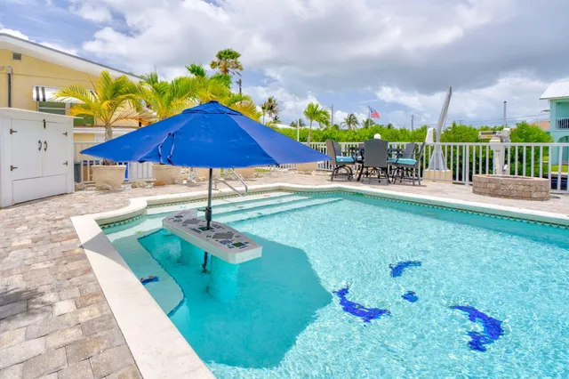 a view of a backyard with sitting area