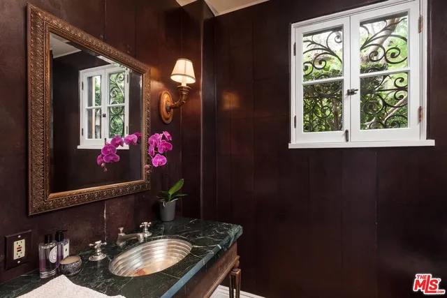 a bathroom with a sink vanity and a mirror
