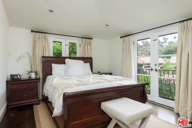 a bedroom with a bed window and a desk